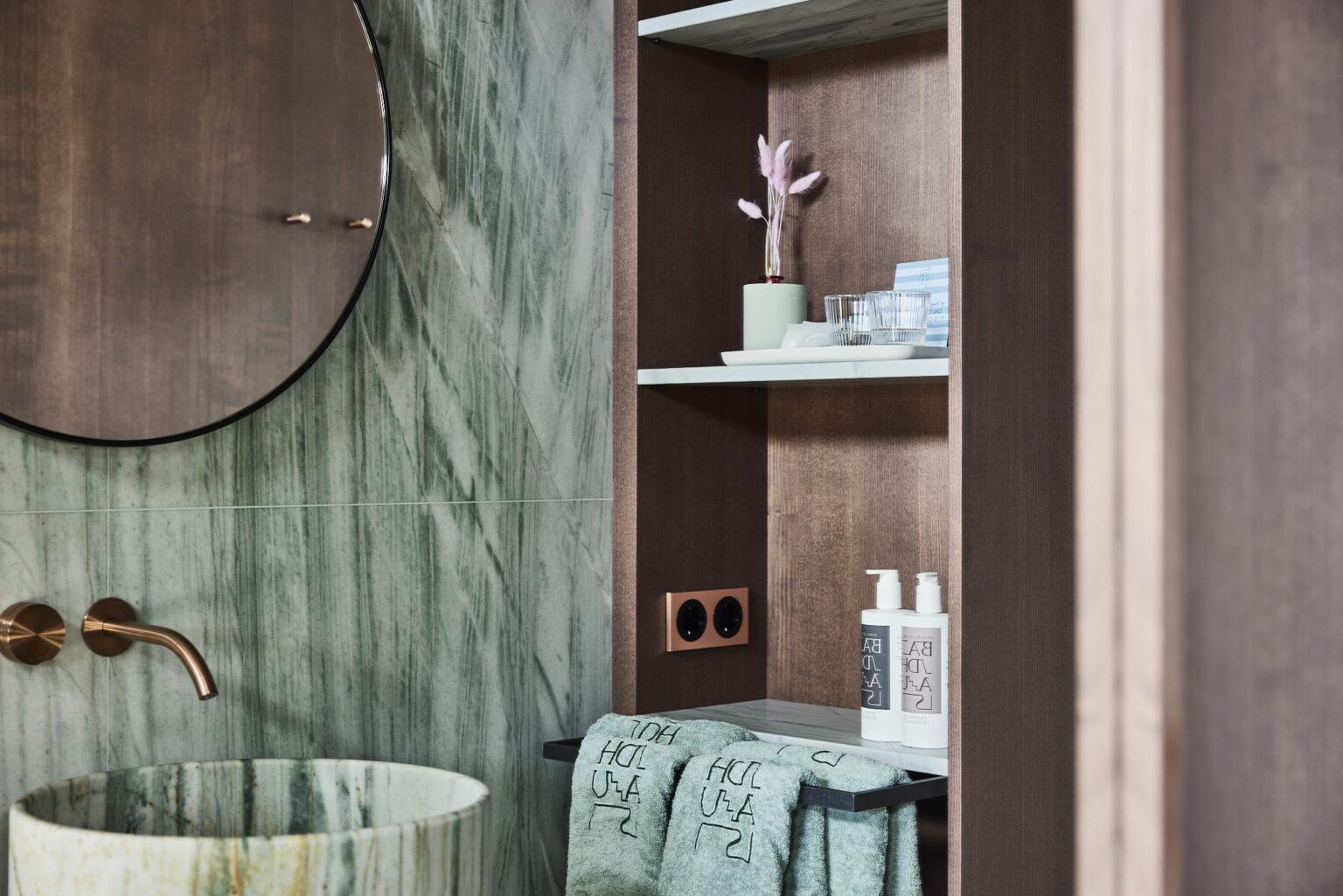 Helles Turmzimmer im Boutique Hotel Badhaus mit italienischen Leinen und Holzboden, Blick auf den Sanitärbereich.